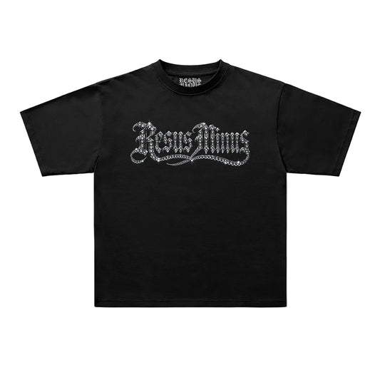 A black short-sleeve t-shirt with a silver gothic-style 'JesusMoms' graphic printed across the chest, displayed flat against a light gray background.