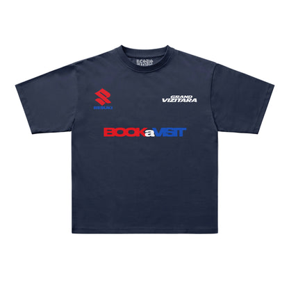 A navy blue short-sleeve t-shirt with multiple sponsor logos printed on the front, including 'BOCKaVISIT' in red and blue, 'GRAND VITITARA' in white, and 'R.S.
