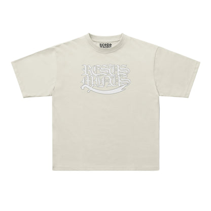 A light beige short-sleeve t-shirt with a stylized white graphic reading 'RESUS MINUS' across the chest, displayed flat against a clean white background.