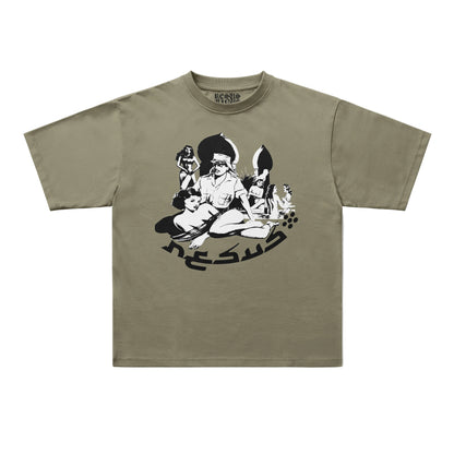 An oversized short-sleeve t-shirt in olive green with a black graphic print of a stylized character and the word 'JESUS' on the front, displayed flat against a light gray background.