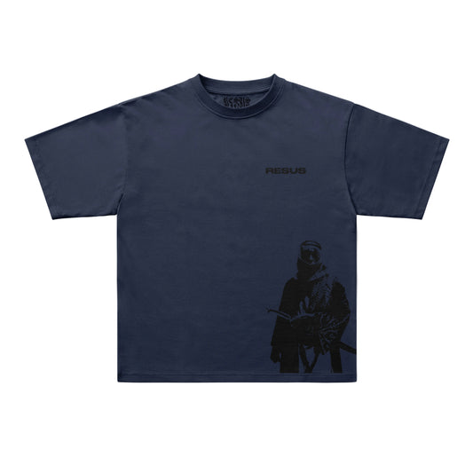 A navy blue short-sleeve t-shirt with a dark graphic print of a soldier on the lower right side and the word 'RESUS' printed on the left chest, displayed flat against a light gray background.