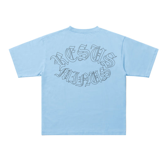 A light blue short-sleeve t-shirt shown from the back, featuring a stylized gothic outline graphic that reads 'JESUS IS MY GOD' in dark gray.