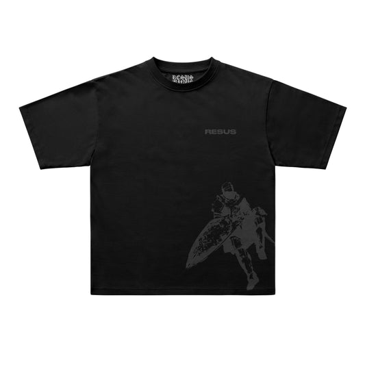 A black short-sleeve t-shirt with a dark gray graphic of a warrior holding a shield on the lower right side and the word 'RESUS' printed on the upper chest. The brand 'ICONIC RETAIL' is visible on the inner neck label.
