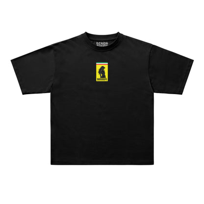 A black short-sleeve crewneck t-shirt with a tonal rectangular patch on the left chest, displayed flat against a white background.