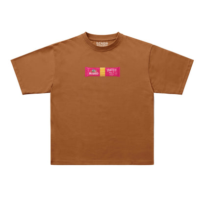 A brown short-sleeve t-shirt with a small graphic on the chest featuring two pink rectangular logos that read 'RISKO' and 'SLATTER'. The t-shirt is displayed flat against a clean, off-white background.