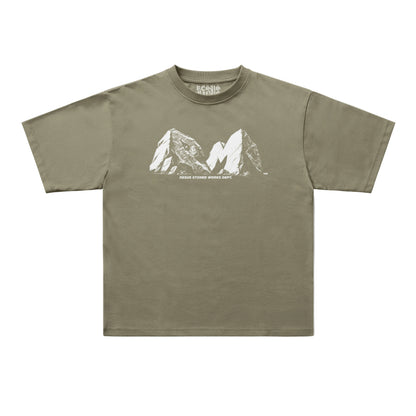 An olive green short-sleeve t-shirt with a white line art graphic of mountain peaks and the text 'MOUNT EVEREST MOUNT K2' on the chest, displayed flat against a light gray background.