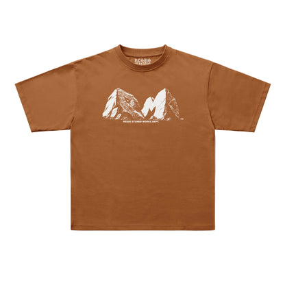 A brown short-sleeve t-shirt with a white graphic of two mountain peaks and the text 'RESUS STONED WORKS DEPT.' printed on the chest, displayed flat against a light gray background.