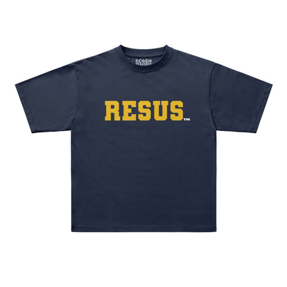 A navy blue short-sleeve t-shirt with the word 'RESUS' printed across the chest in bold yellow varsity-style letters, shown on a light gray background.